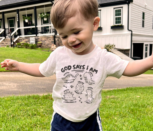 God says I am- Dinosaurs Kid's Christian Graphic Tee